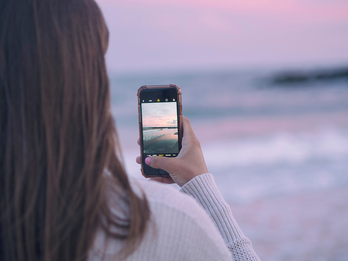 woman-taking-iphone-photo-beach
